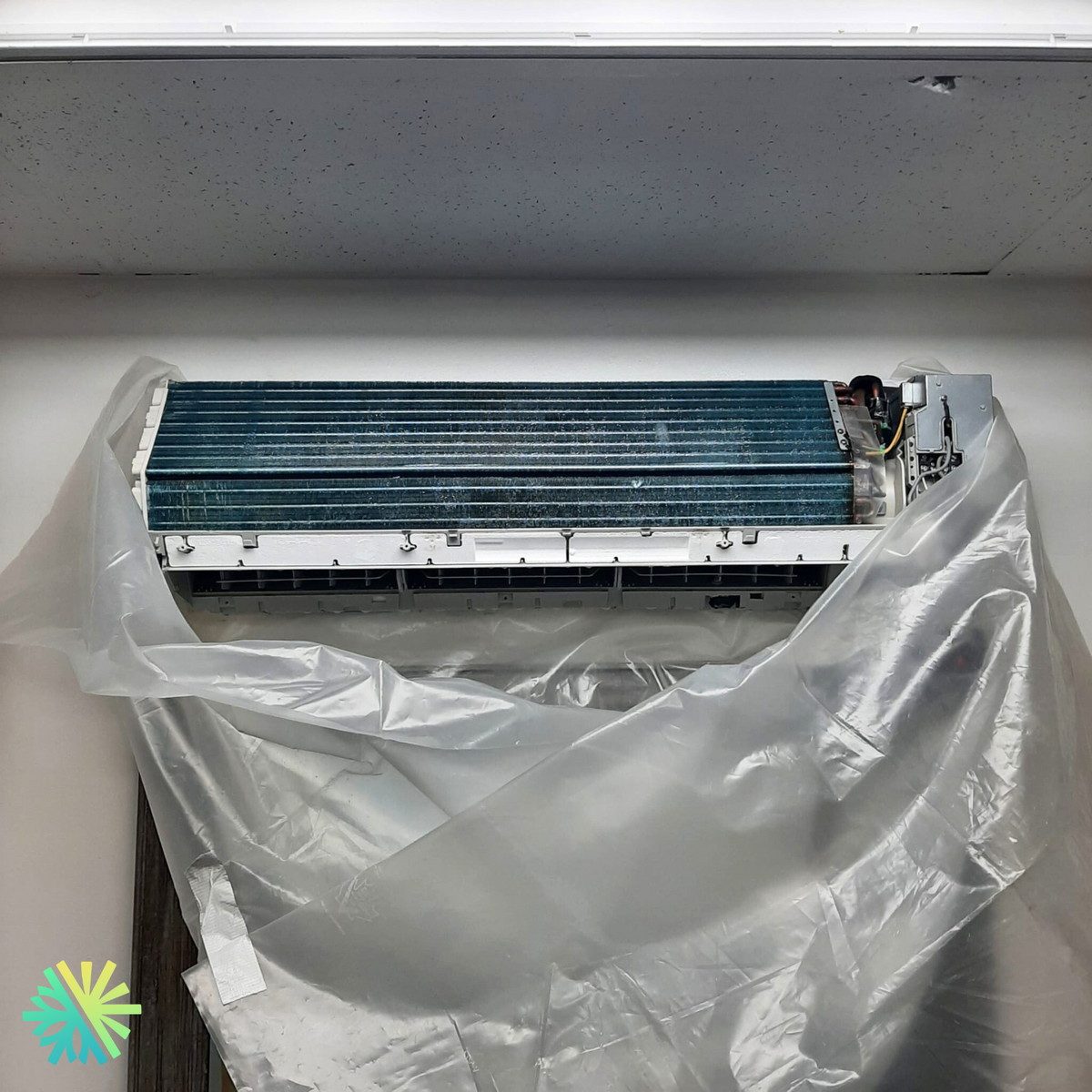 A certified AirGreen technician repairs a wall unit
