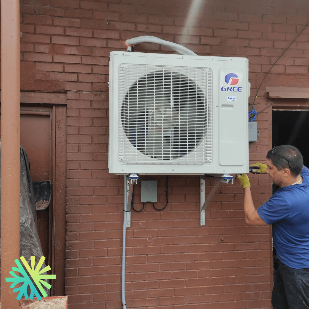 Installation d'une Thermopompe DoubleZone Gree FreeMatch Extreme à Saint-Léonard, Montréal, technicien installant l'unité extérieure.