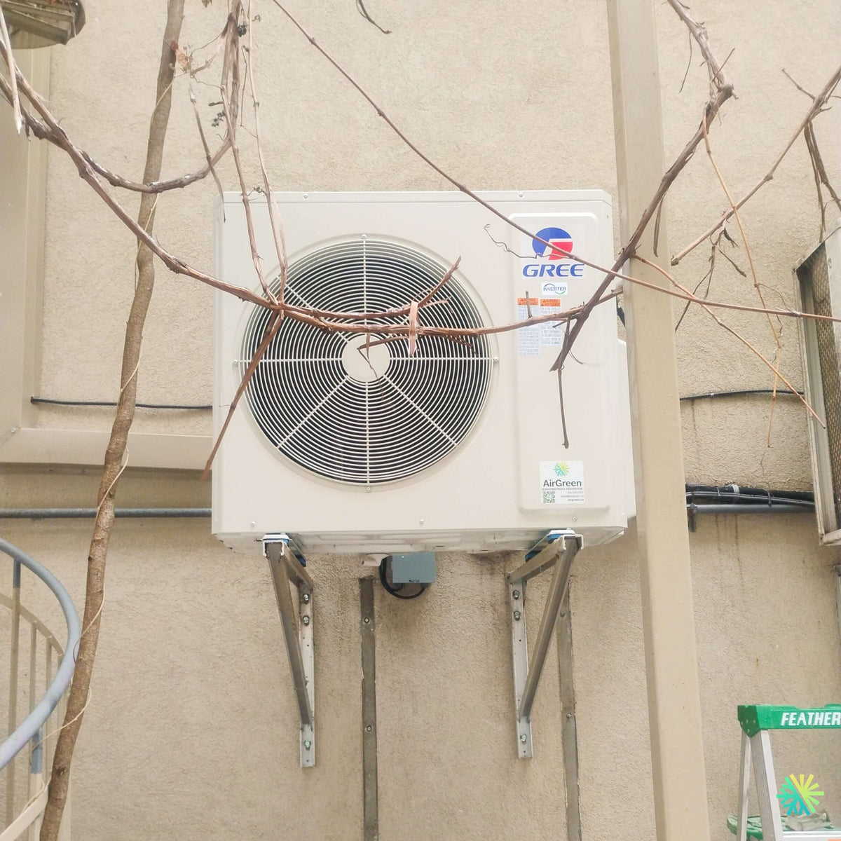 Installation d’une thermopompe GREE FREE MATCH R32 DoubleZone 2 têtes à Saint-Vincent-de-Paul, Laval : une installation CVAC sur supports muraux dans un espace extérieur complexe