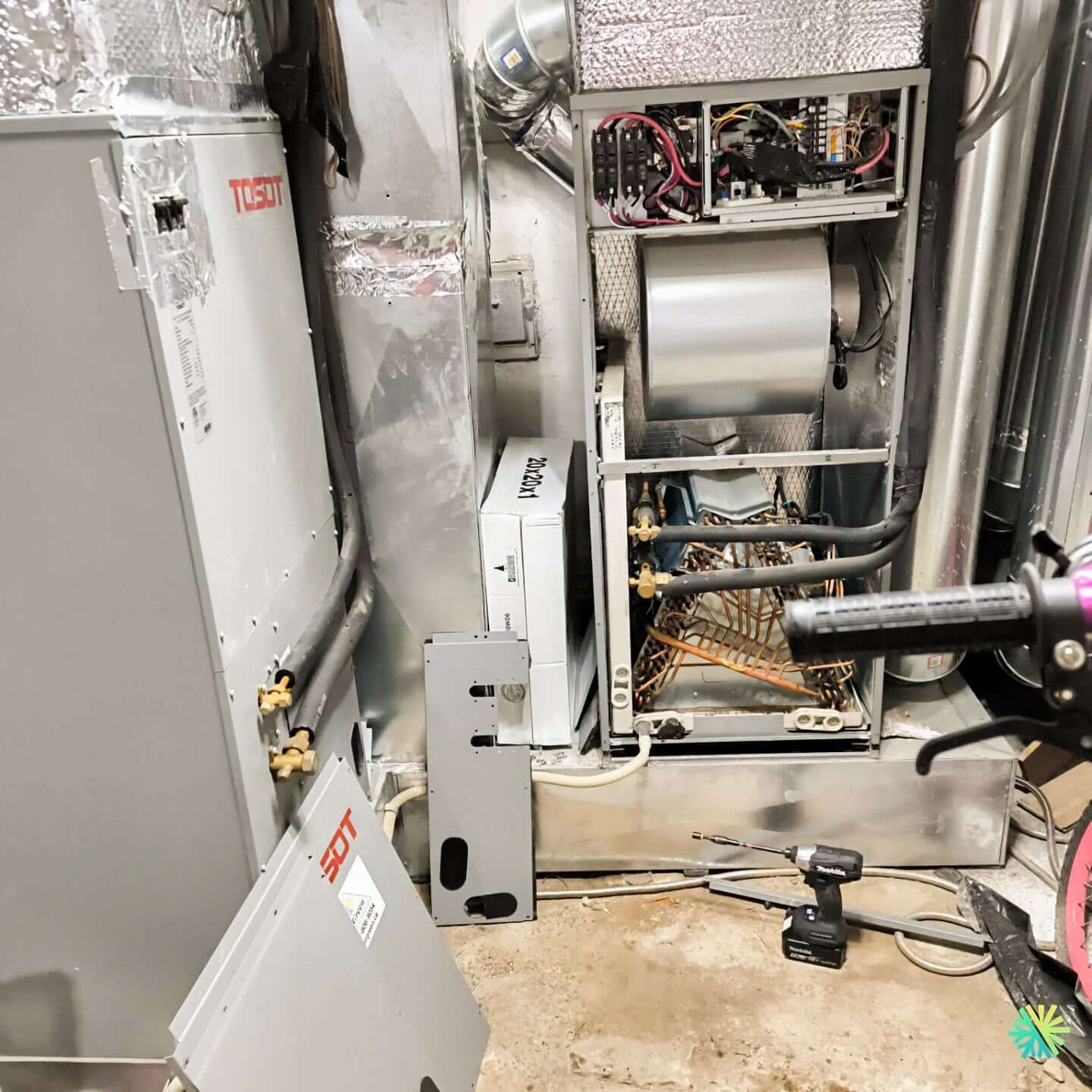 Open HVAC system showcasing internal components and wiring in a mechanical room for maintenance or repair