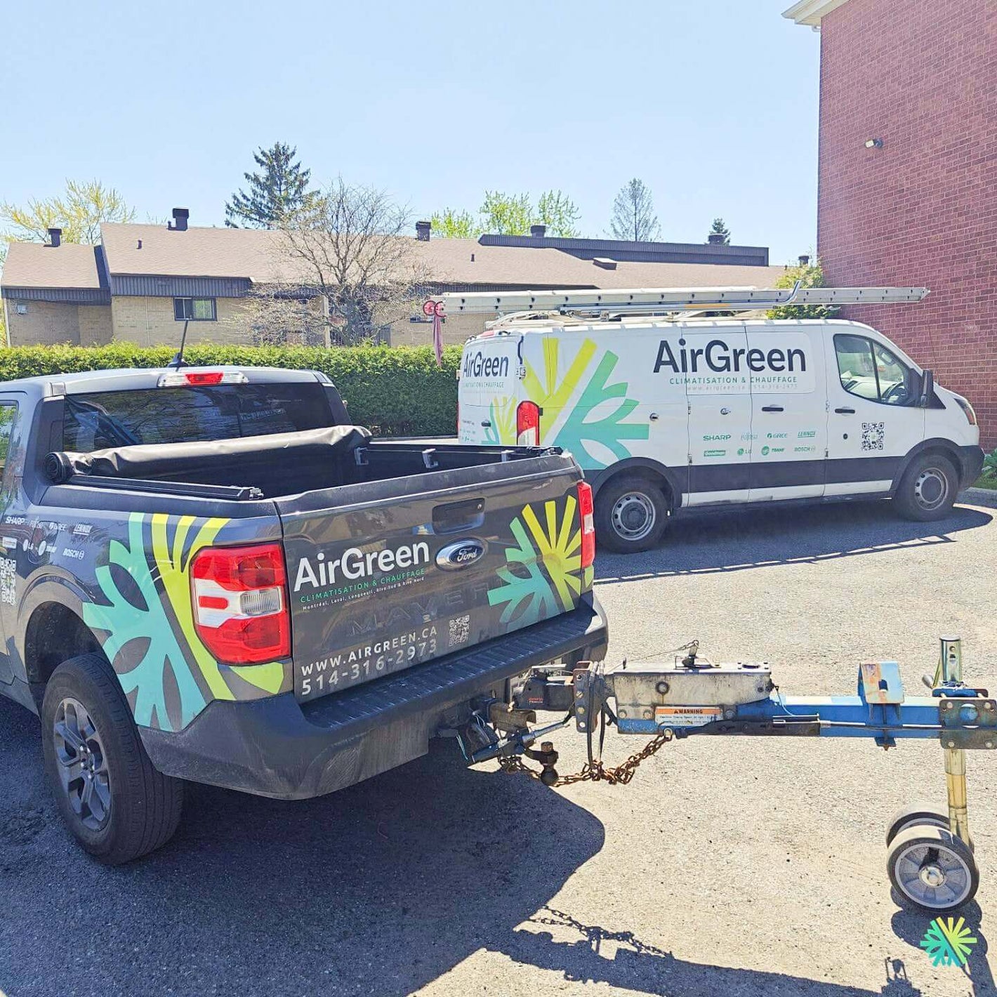 AirGreen branded truck and van parked outdoors, showcasing company vehicles with logos and website URL, under a clear blue sky.