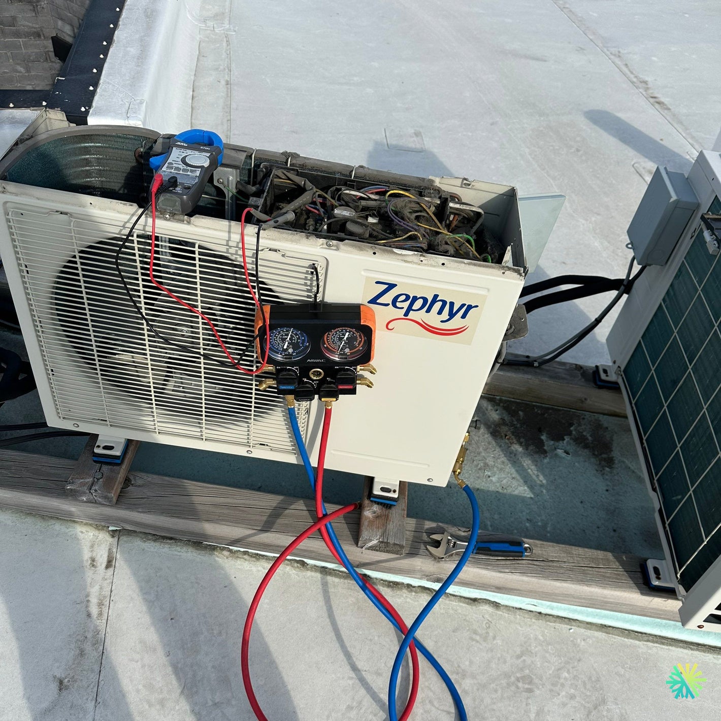 Zephyr HVAC unit on rooftop with pressure gauges for maintenance inspection.