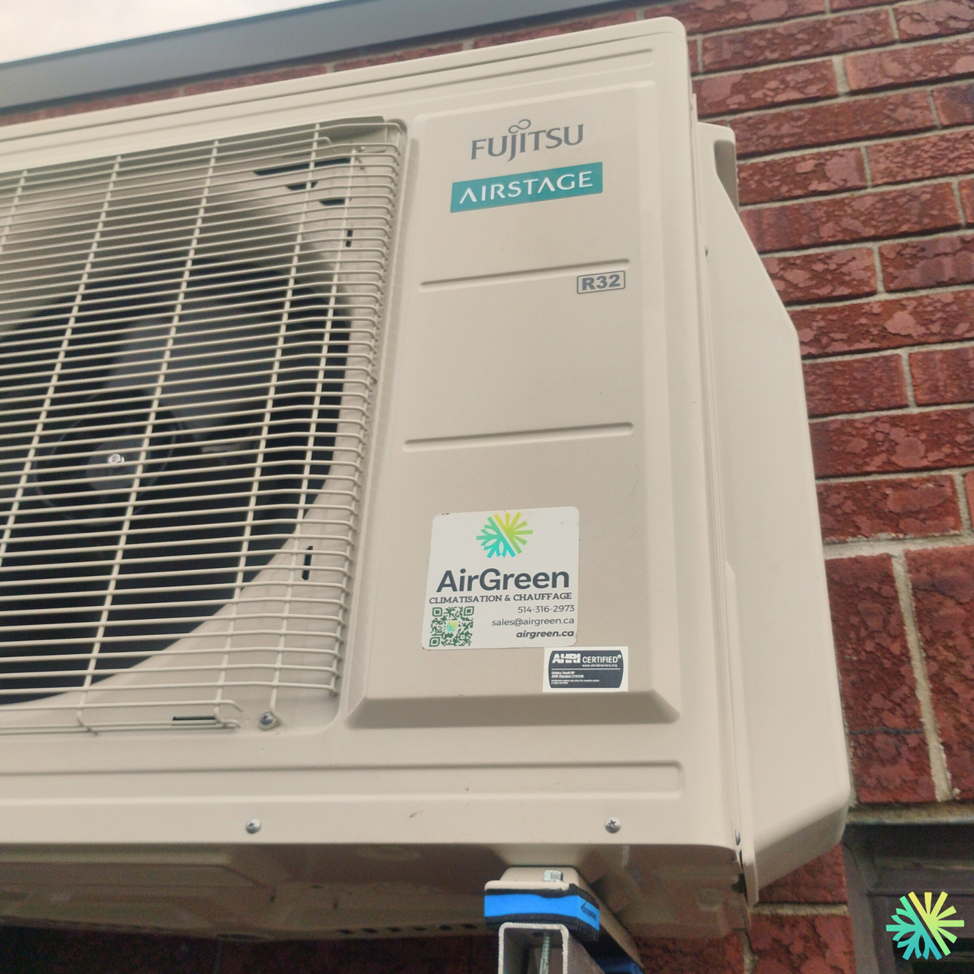 Fujitsu Airstage AirGreen air conditioning unit installed on a brick wall