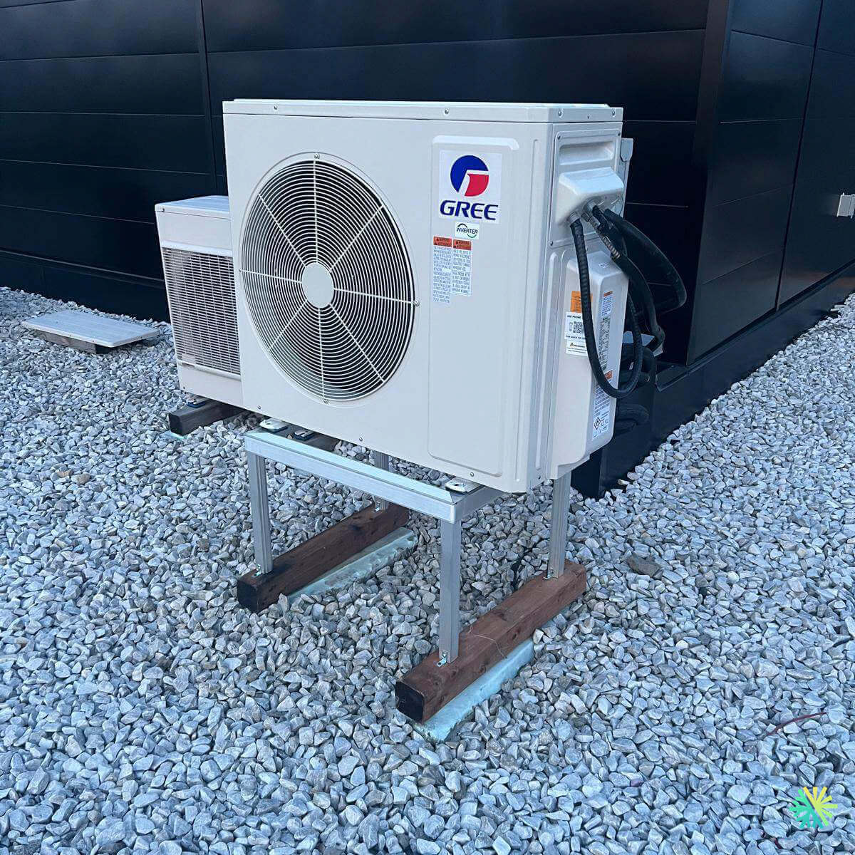 Outdoor Gree mini-split air conditioning unit on a gravel surface
