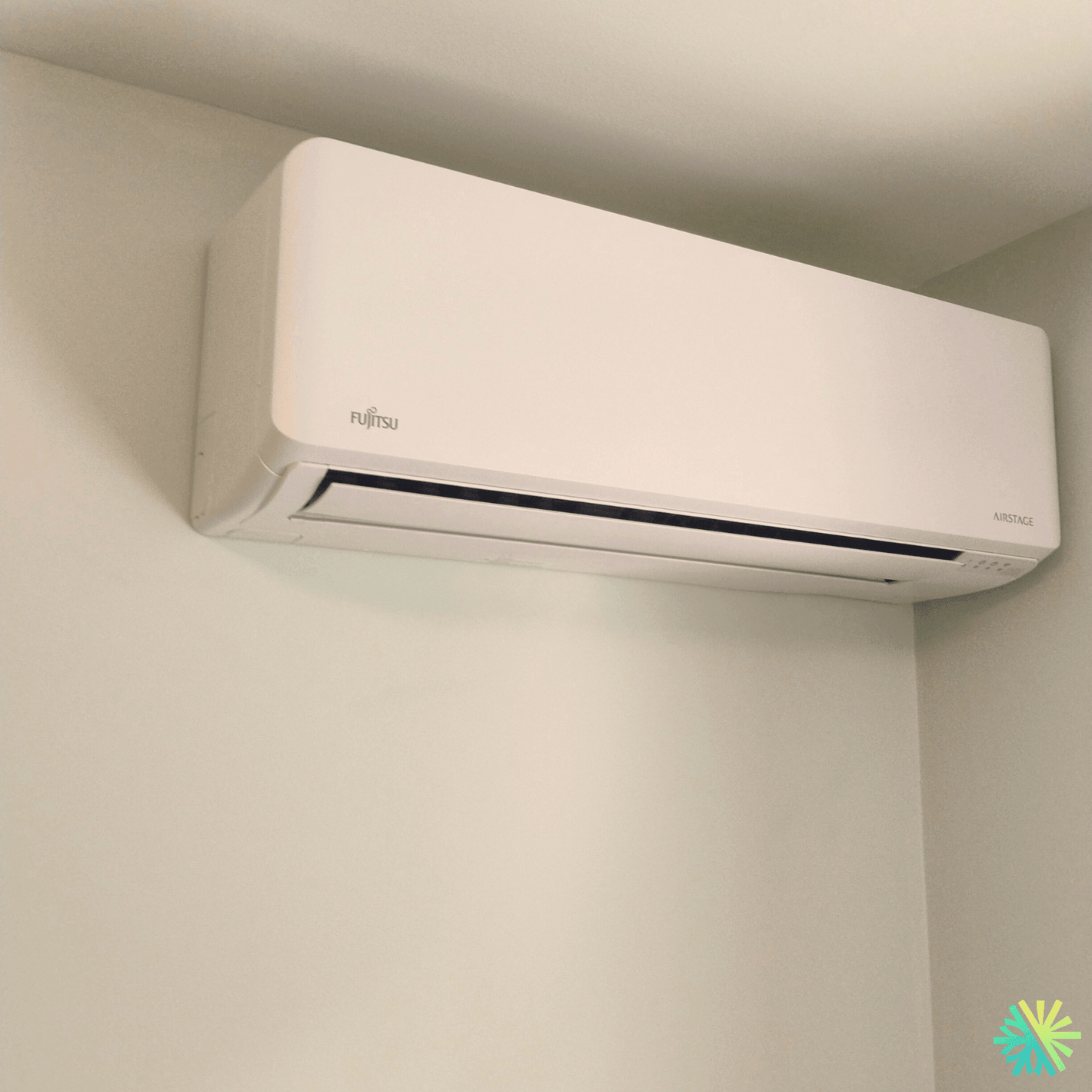 Wall-mounted Fujitsu air conditioner in a modern room setting.