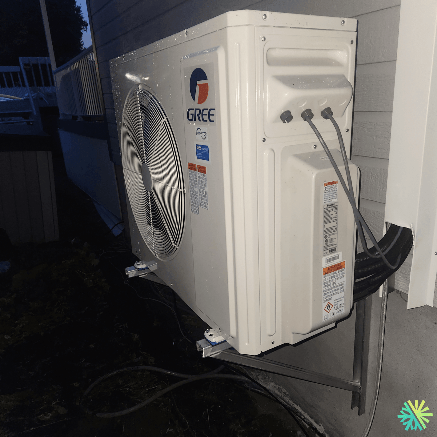 Outdoor Gree air conditioner unit installed on residential building wall