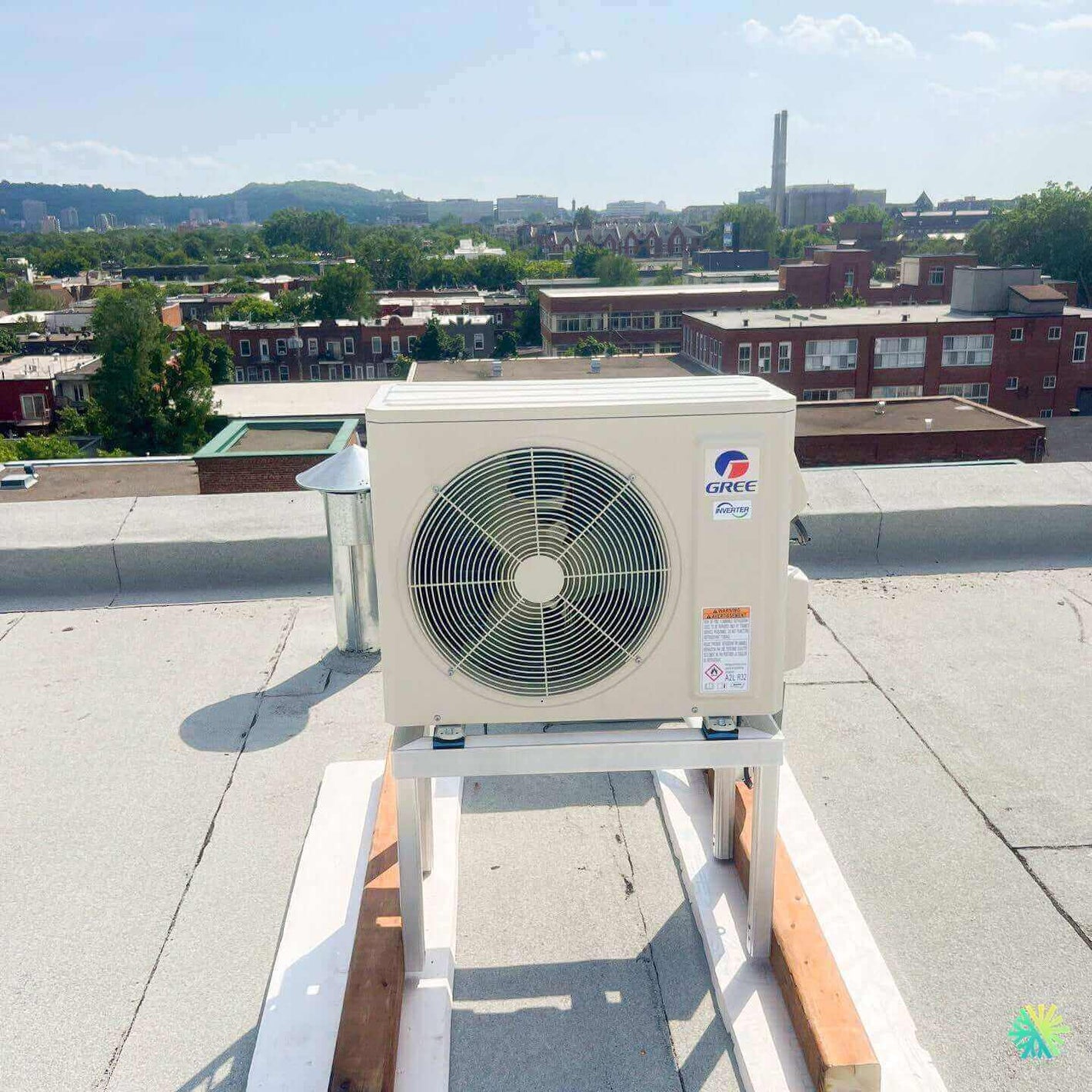 Rooftop Gree air conditioning unit in urban setting with cityscape in the background.