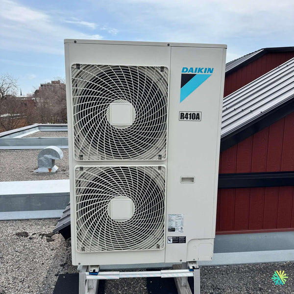 Daikin R410A HVAC unit on rooftop, featuring dual fans for efficient climate control.