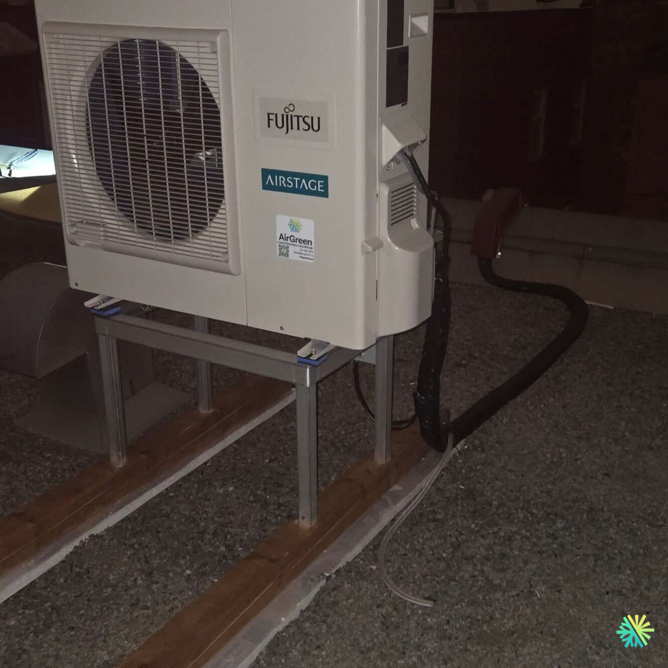 Outdoor Fujitsu Airstage HVAC unit installed on a gravel base, showcasing energy-efficient functionality.