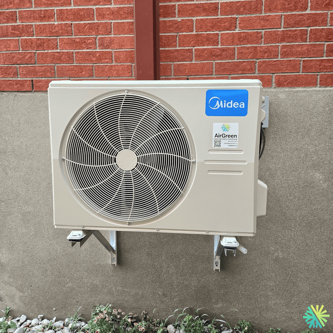 Outdoor air conditioning unit installed on brick wall for efficient cooling.