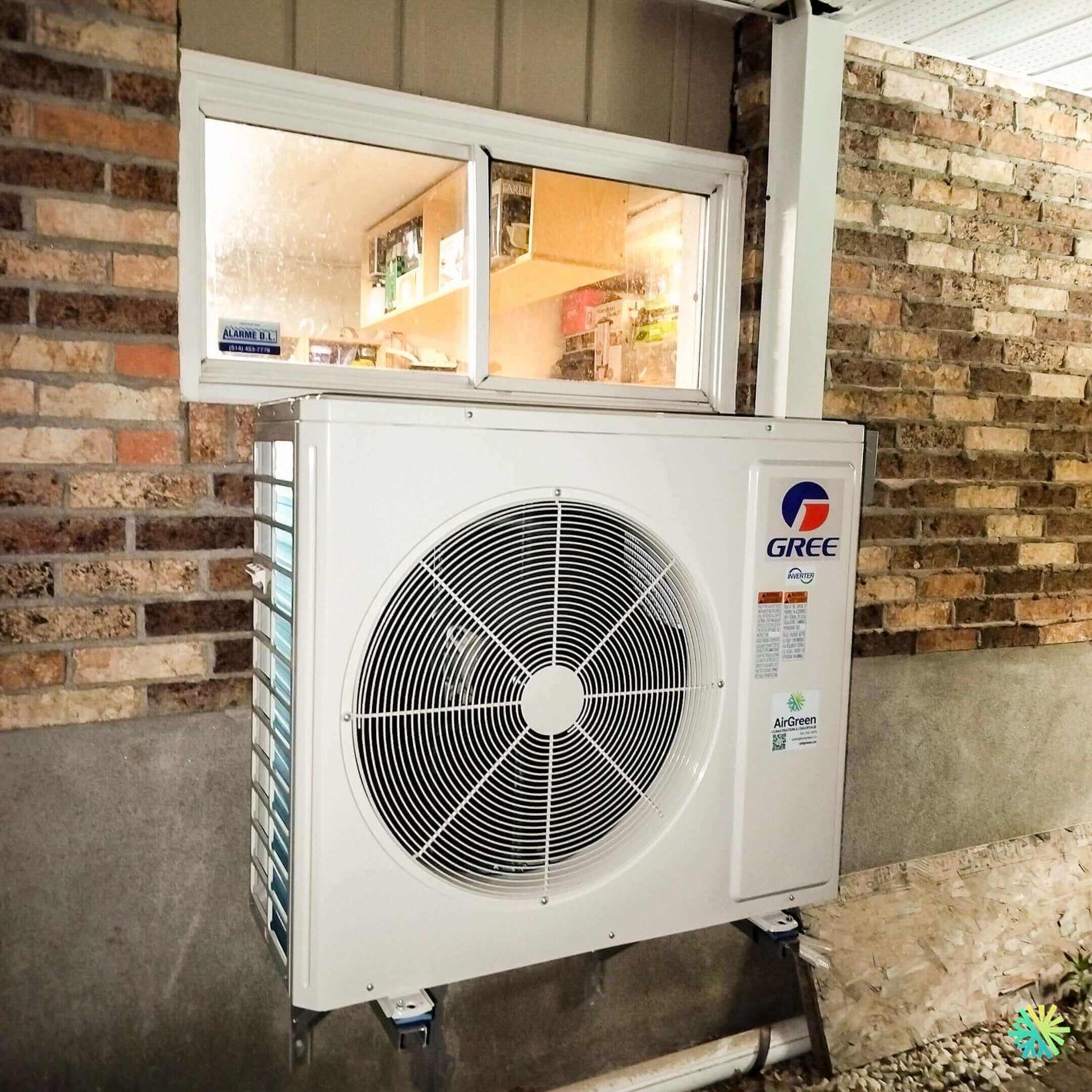 Gree outdoor air conditioning unit mounted on a brick wall for efficient cooling.