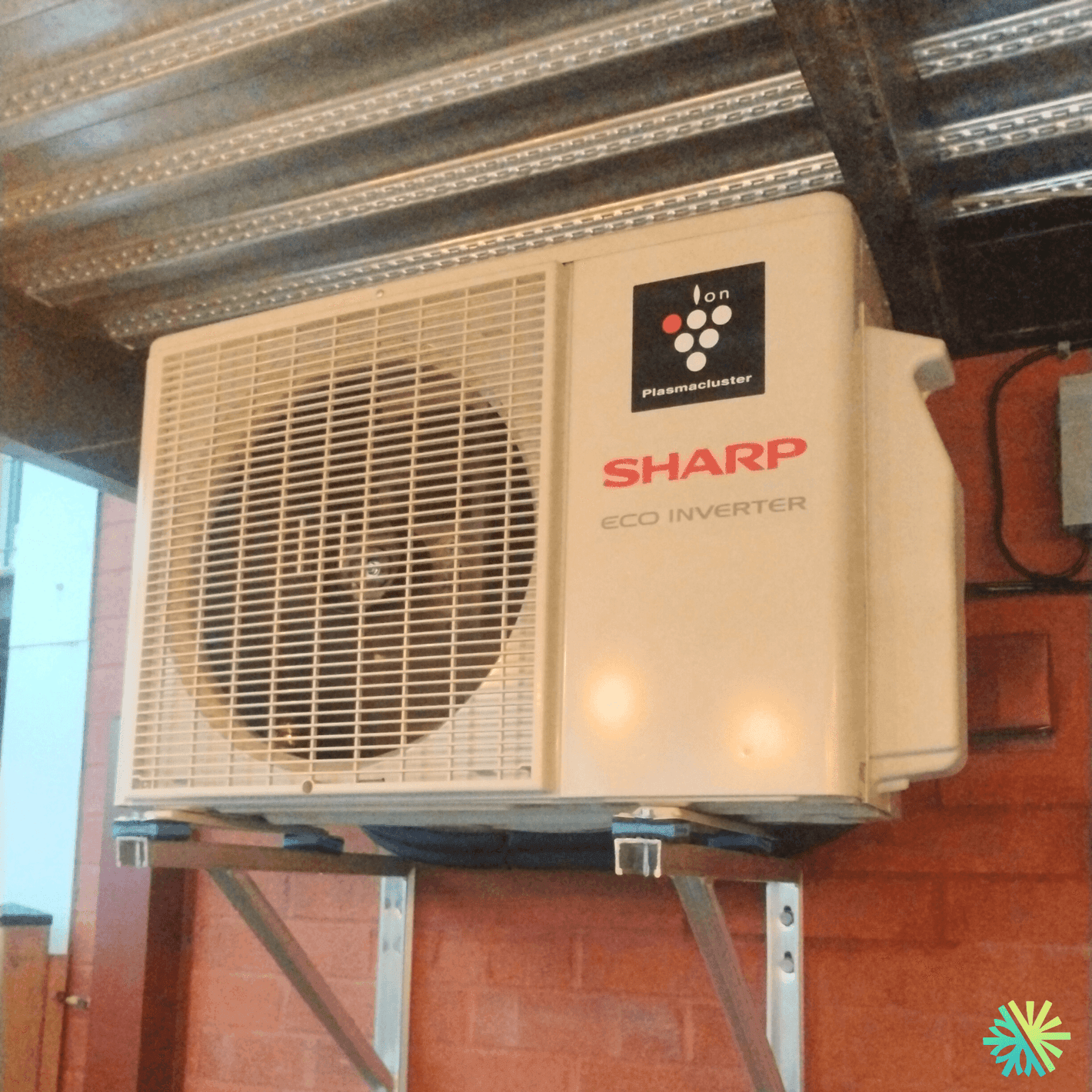 Sharp Eco Inverter air conditioning unit mounted on a wall, showing its ventilation system and branding.