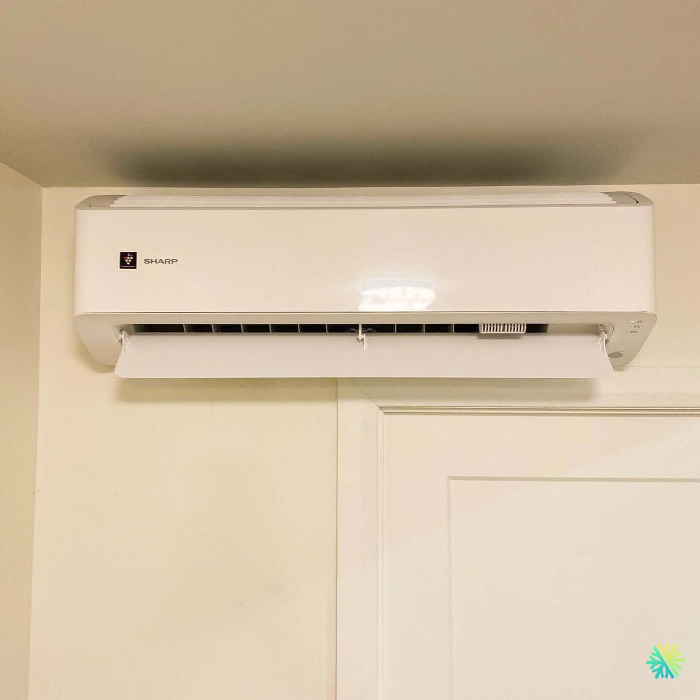 Wall-mounted air conditioner unit in a room, highlighting efficient and compact design for cooling spaces.