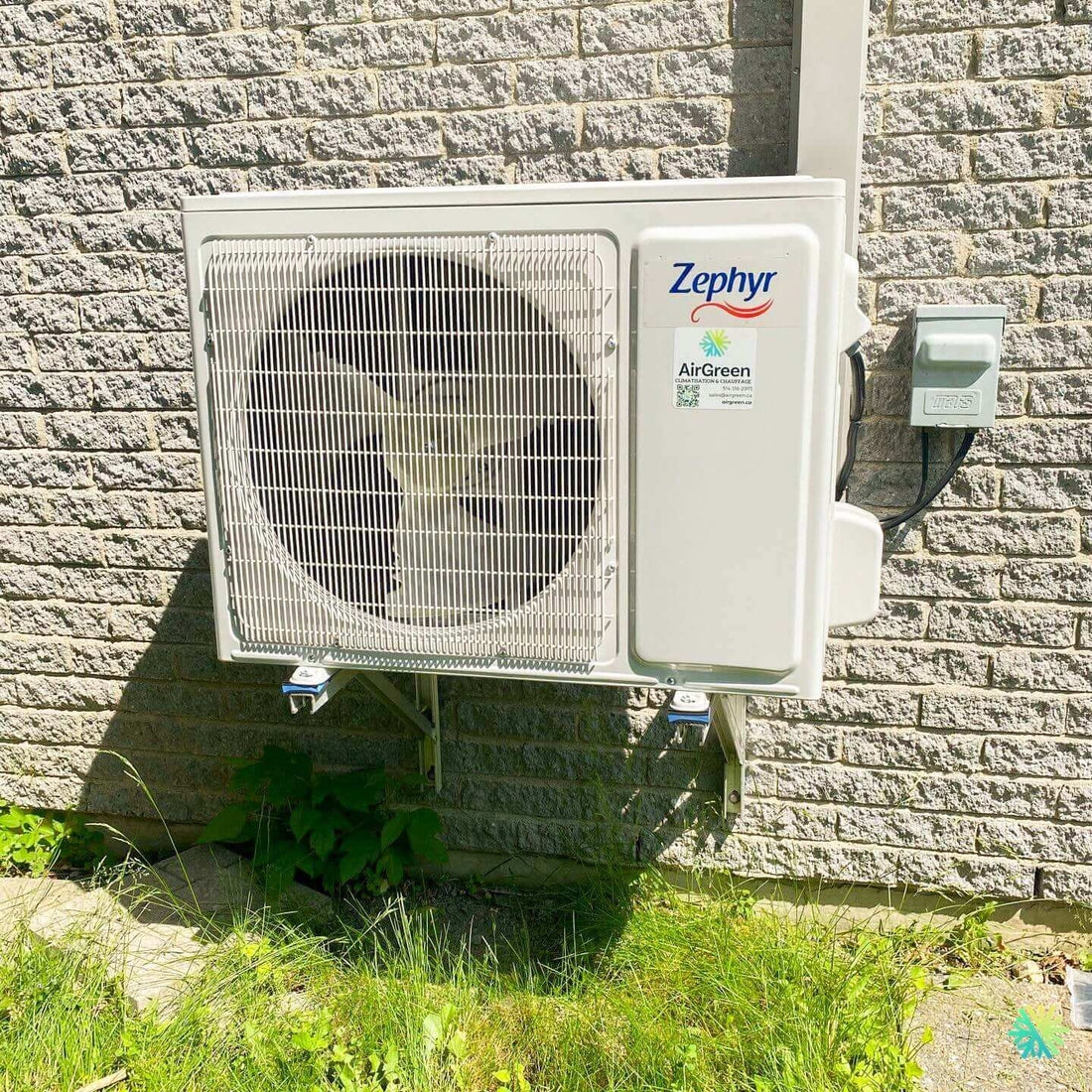 Outdoor Zephyr air conditioning unit mounted on a brick wall, part of an energy-efficient home cooling system.