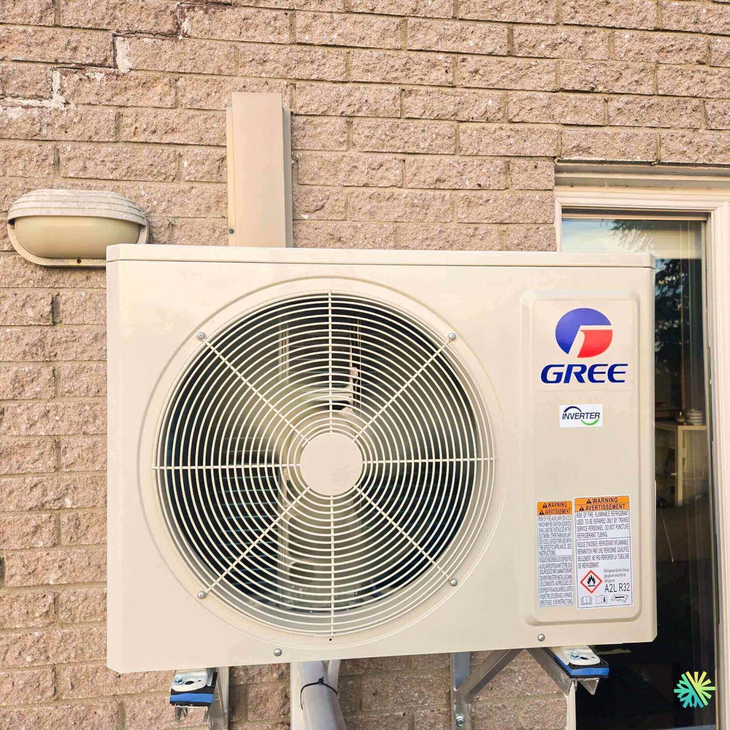Gree outdoor air conditioning unit mounted on a brick wall, showcasing energy-efficient HVAC technology.