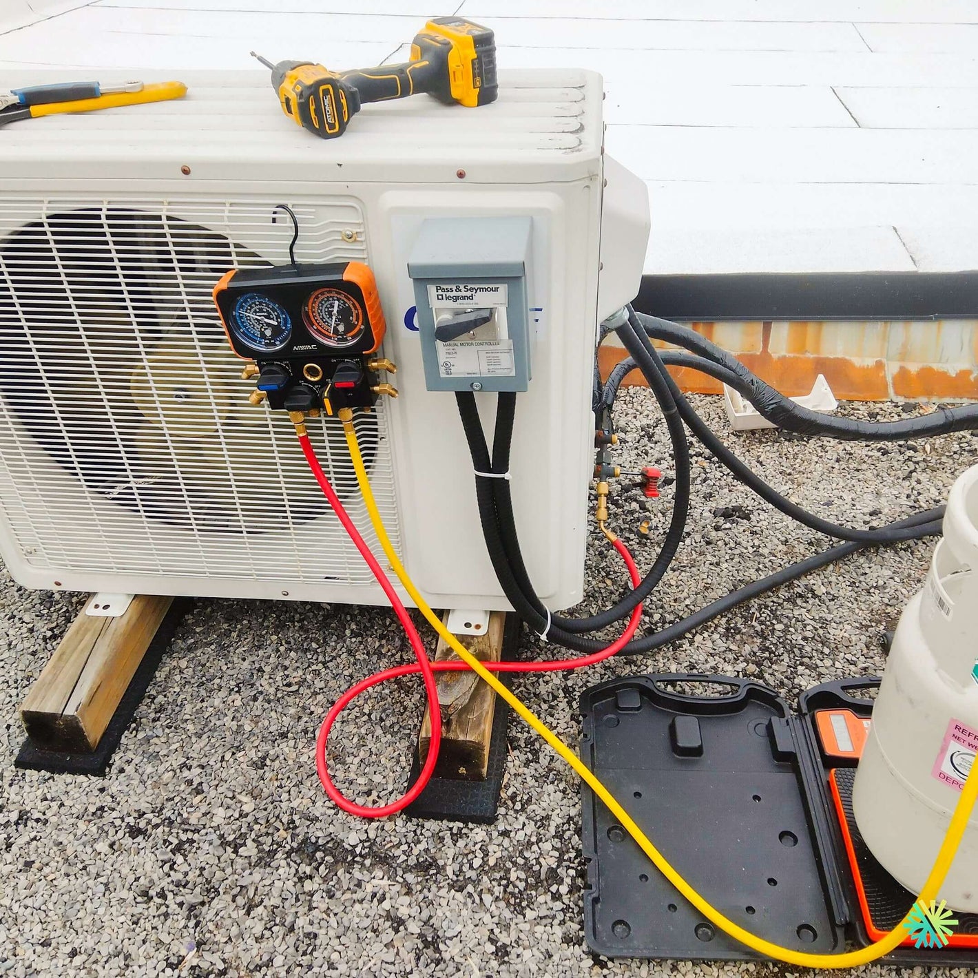 HVAC system maintenance with refrigerant gauges and tools on rooftop, demonstrating air conditioning repair process.