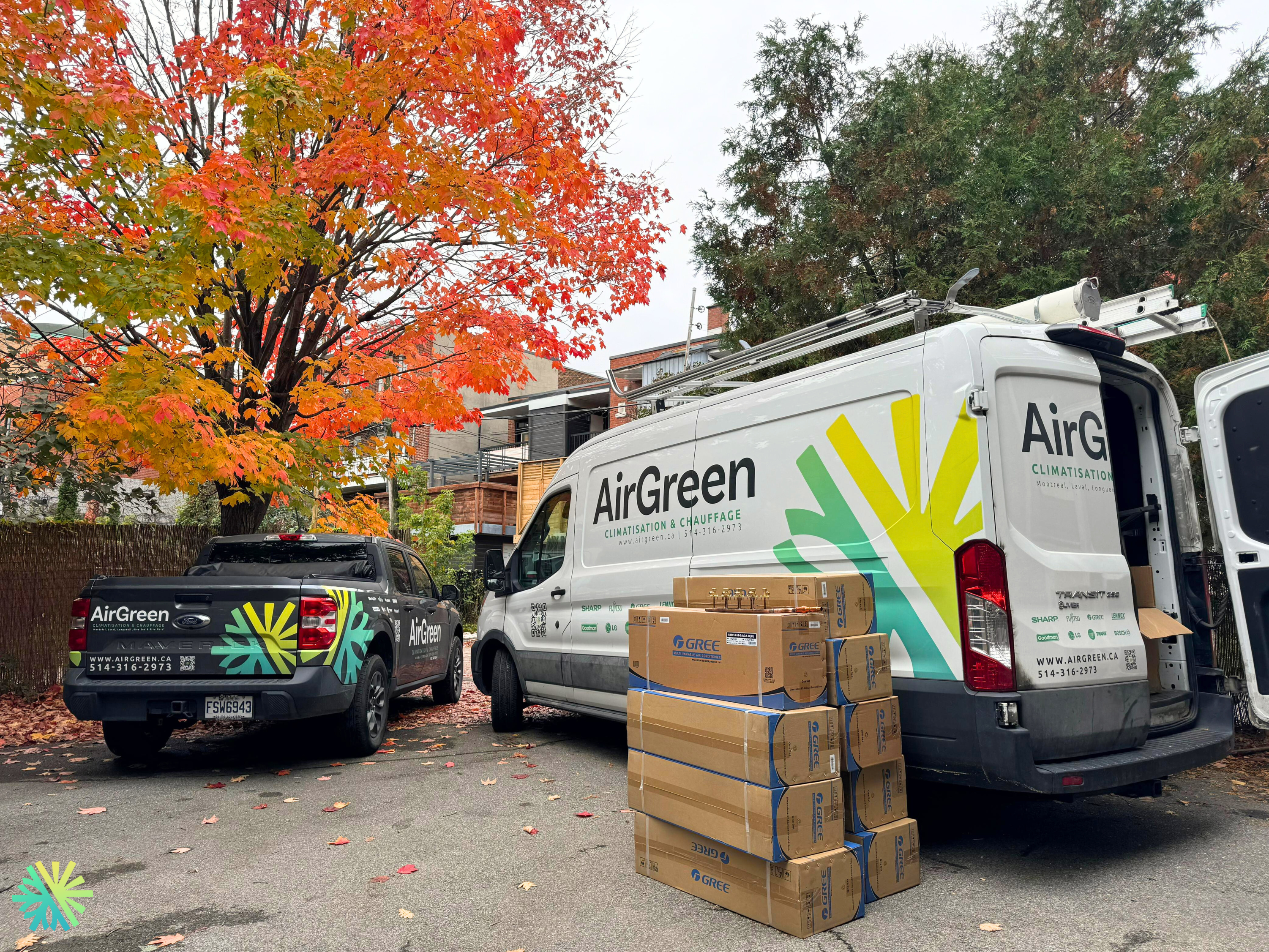 AIRGREEN COMPANY TRUCK AND VAN WITH MANY MINI SPLIT BOXES ON THE FLOOR NEAR THE TRUCK
