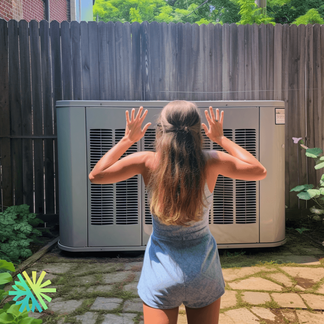 Person standing in front of a large outdoor power generator unit, with hands raised towards the unit, surrounded by a wooden fence.