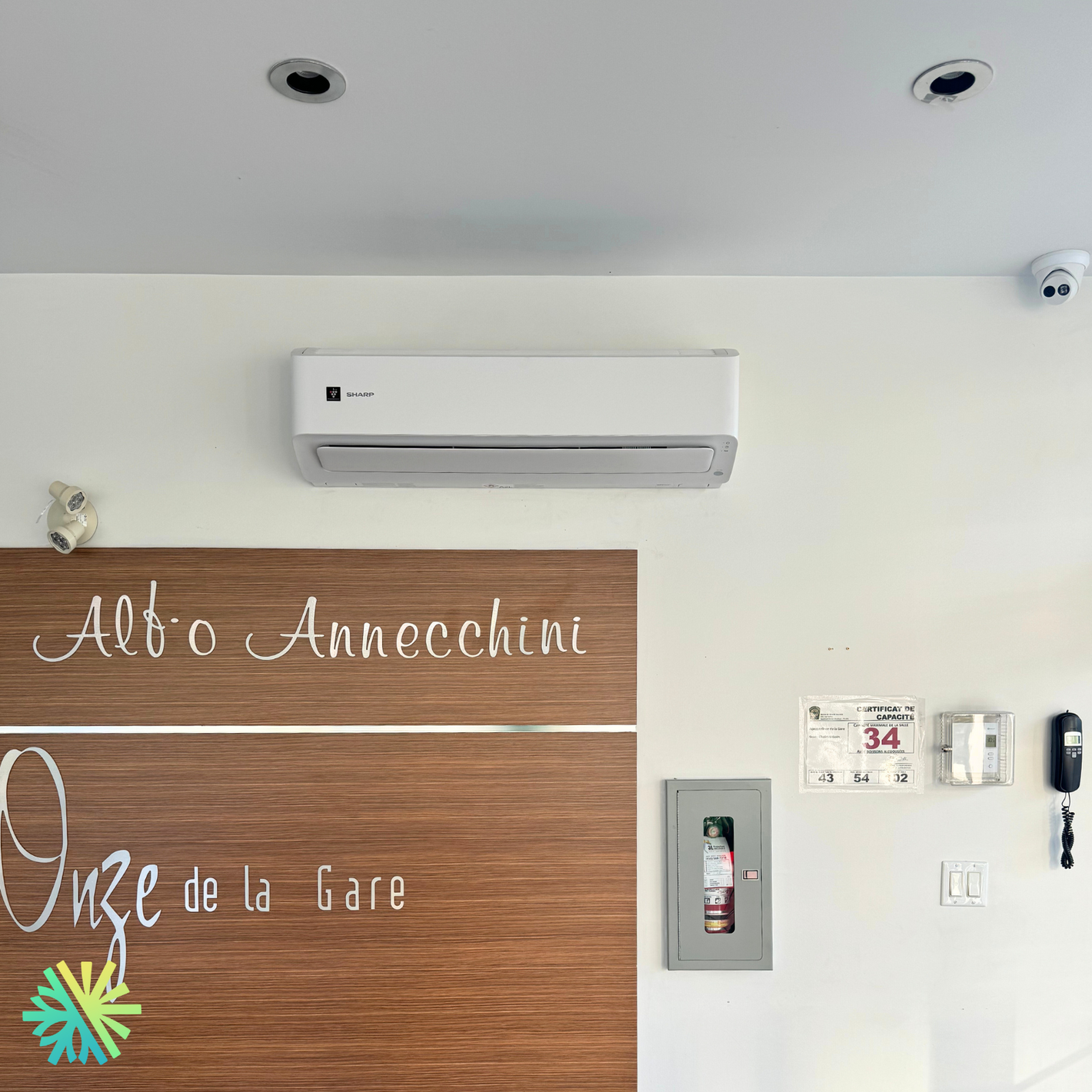 Wall-mounted air conditioning unit in interior space with wooden accent, providing cooling in a modern setting.