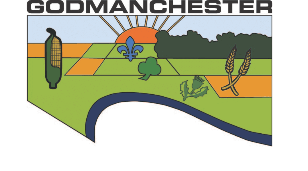 Town of Godmanchester emblem featuring a colorful landscape with sun, wheat, corn, and a fleur-de-lis symbol.