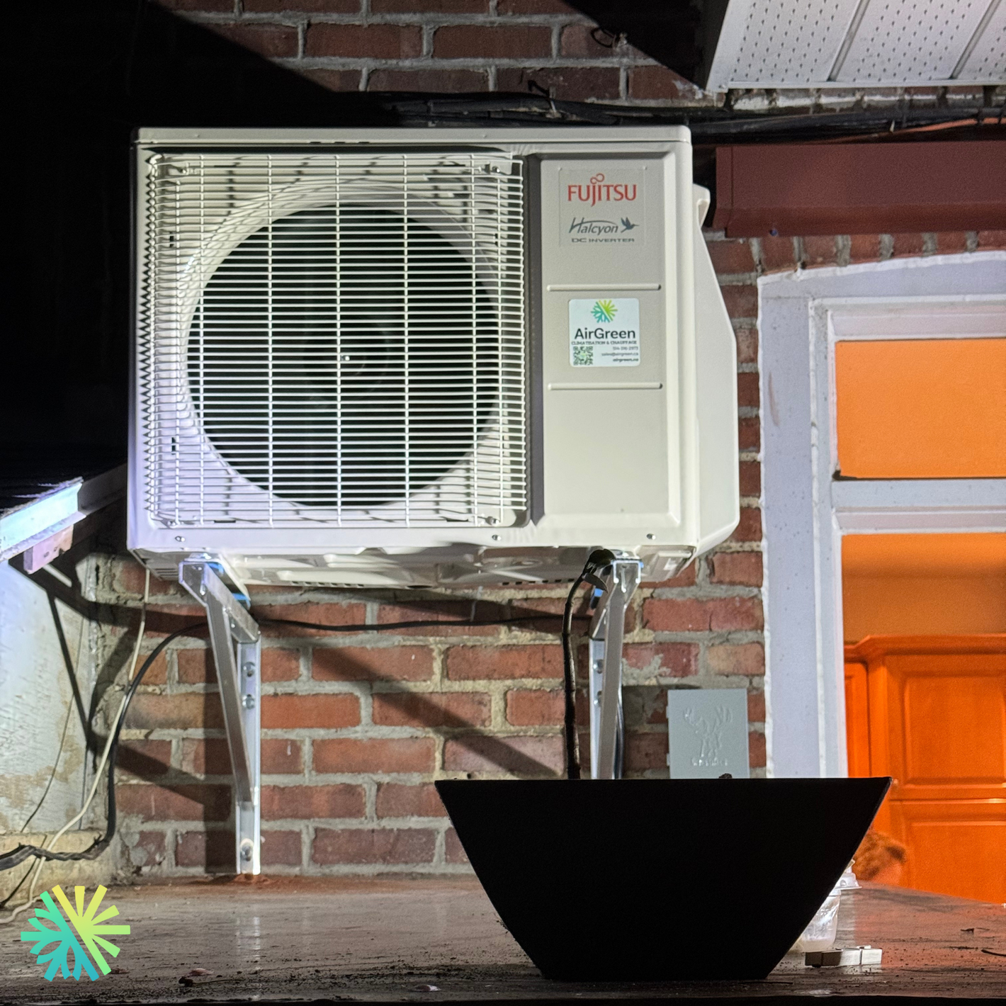 Fujitsu air conditioner unit installed on a brick wall, highlighting energy efficiency features for residential use.