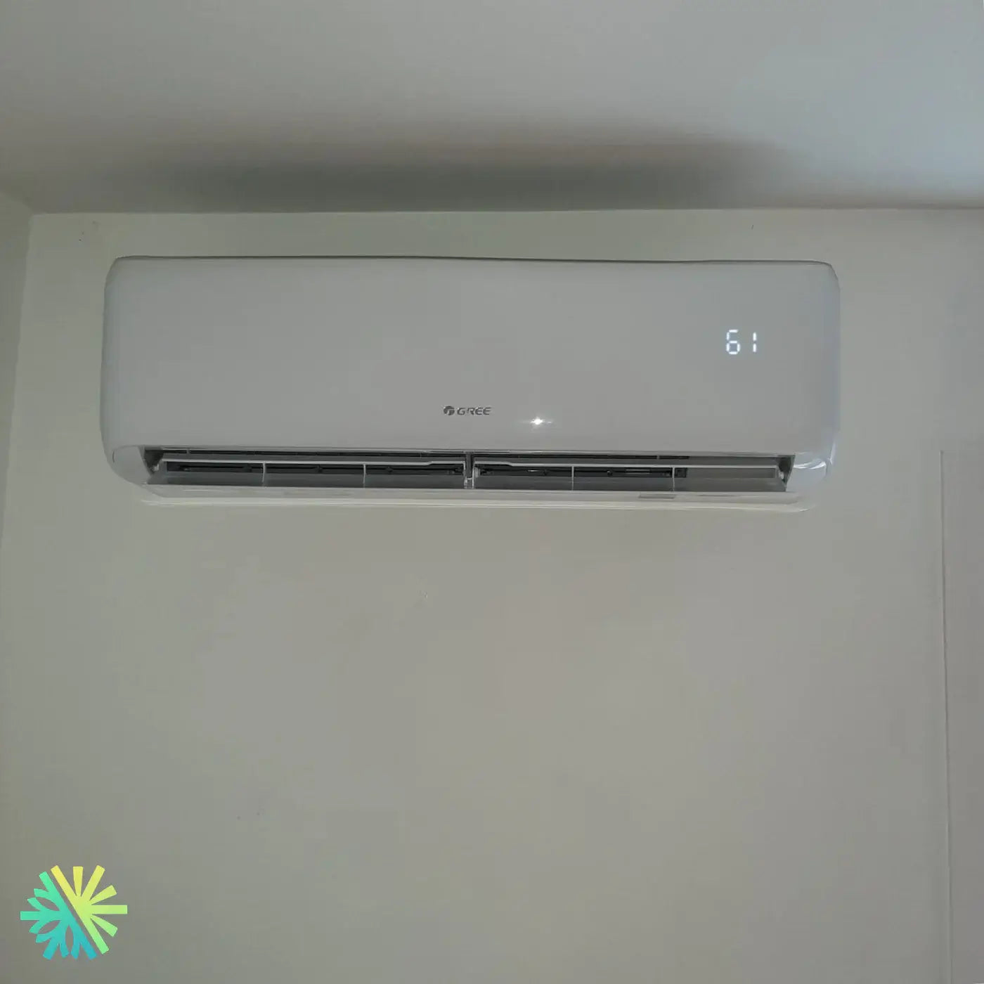 Wall-mounted air conditioner with LED display showing temperature