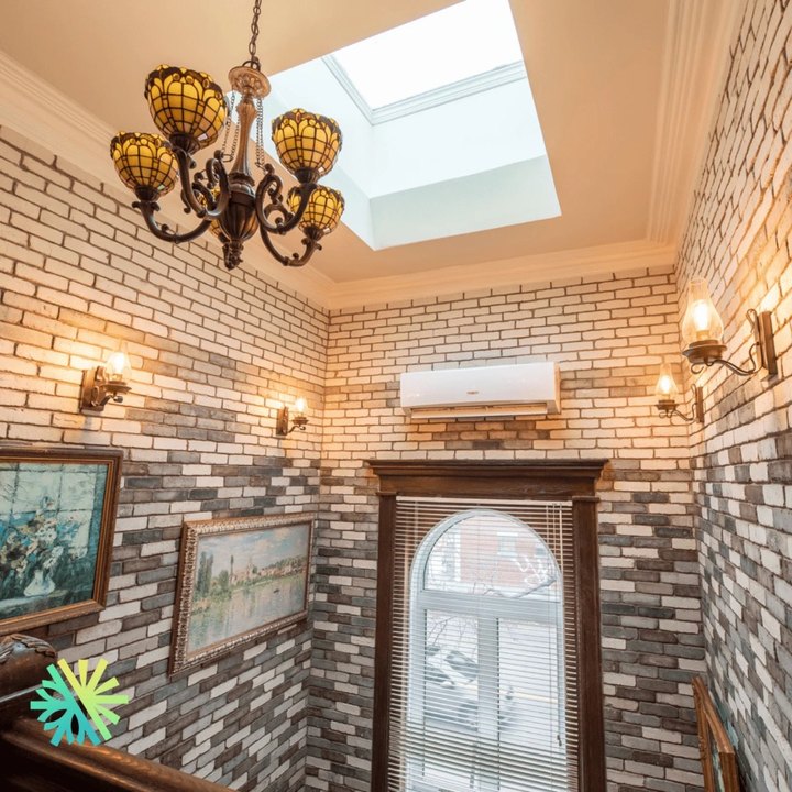 TOSOT Ultra Heat wall-mounted heat pump installed by AirGreen in a brick stairwell with a skylight, in Montreal